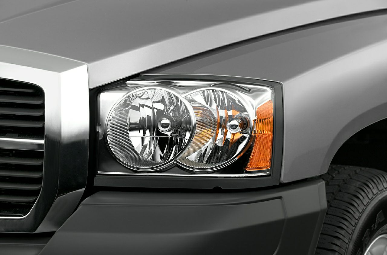 Close-up of front headlight and grill on a vehicle.