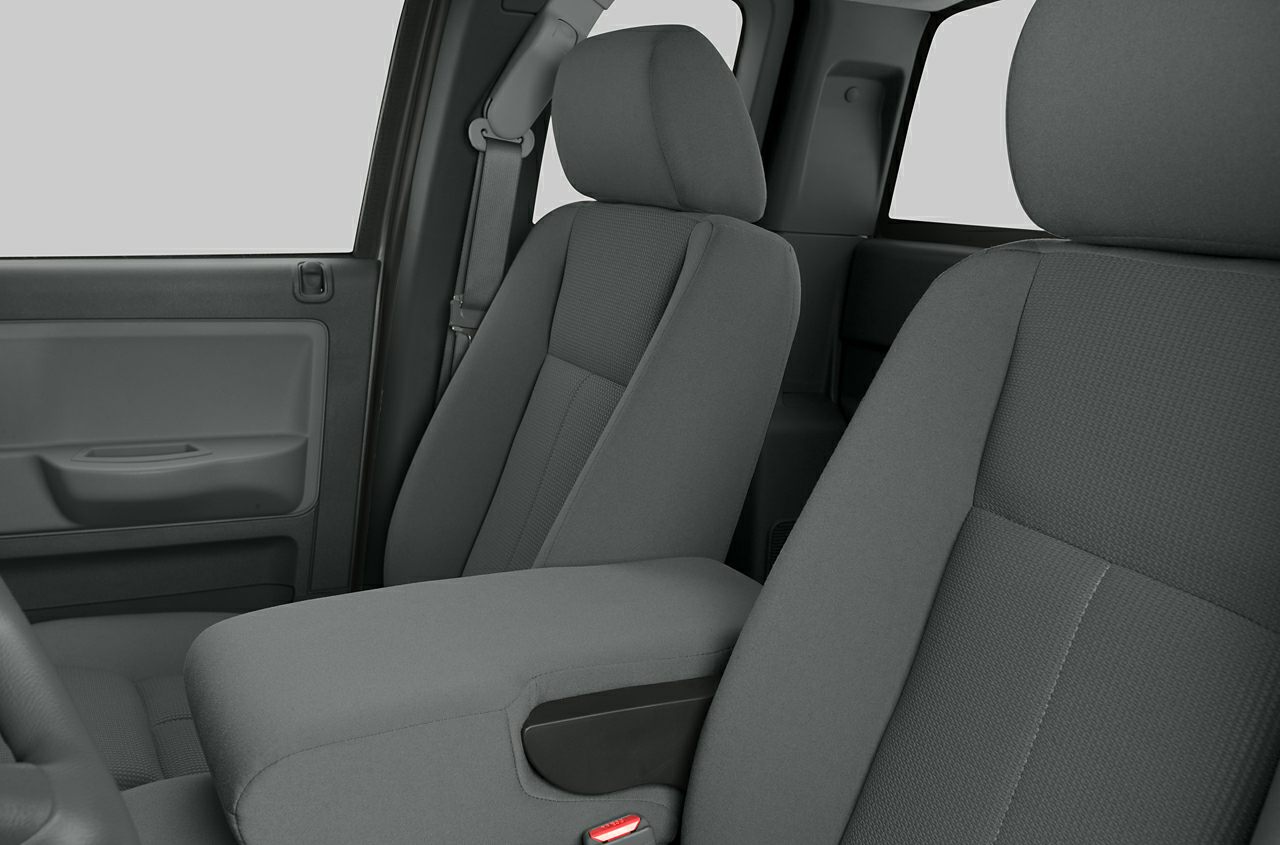 Close-up of front seats and center armrest in car interior