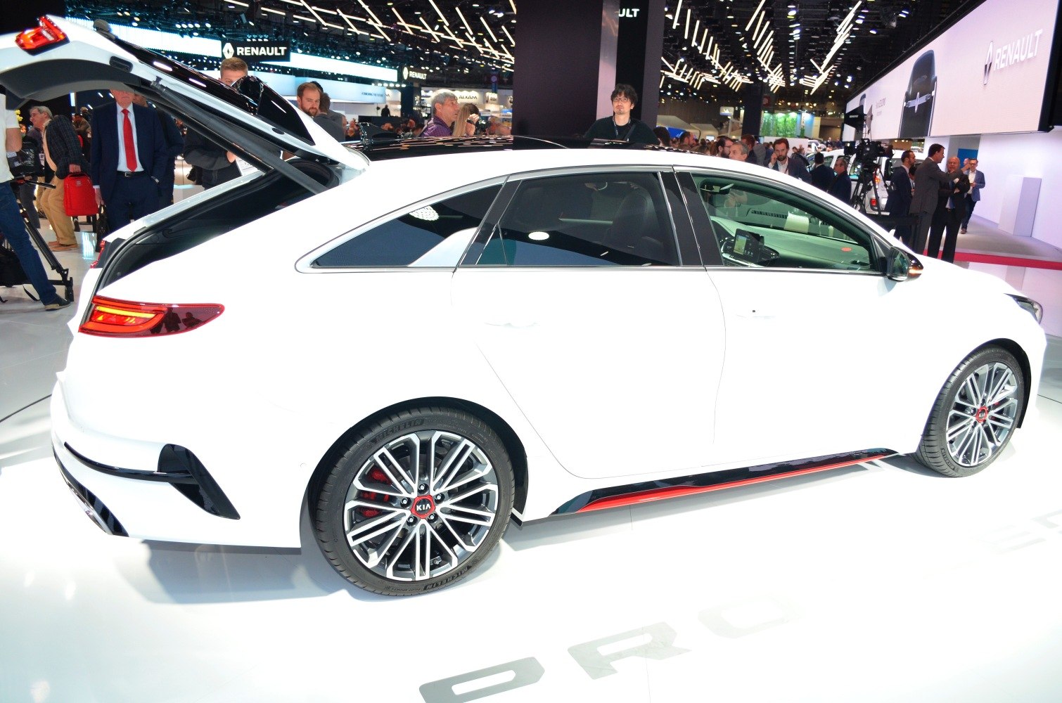 White hatchback with open rear hatch and sporty alloy wheels