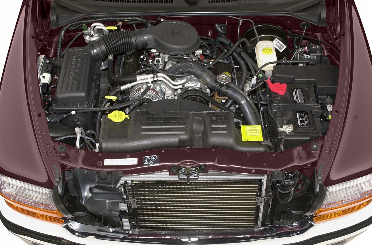 Engine bay with visible intake, radiator, battery, and fluid reservoirs.
