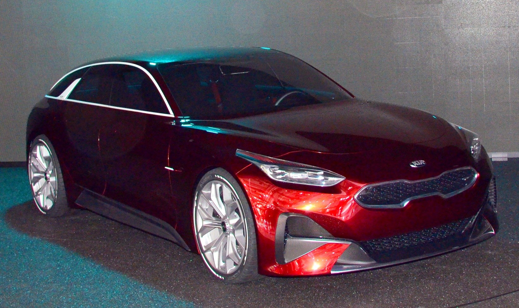 Futuristic red hatchback with aggressive front and sporty alloy wheels