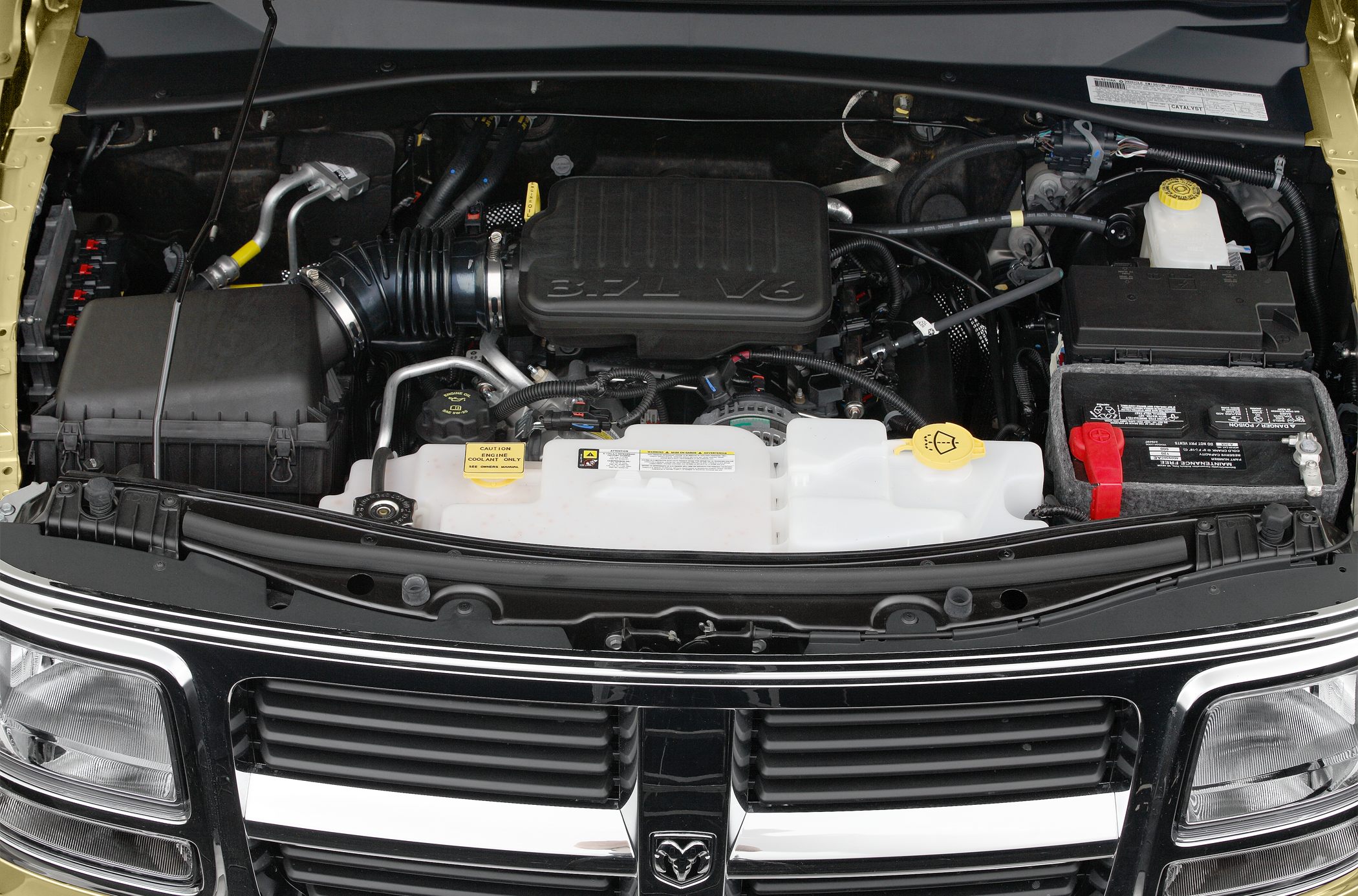 3.7L V6 engine bay with battery and fluid reservoirs