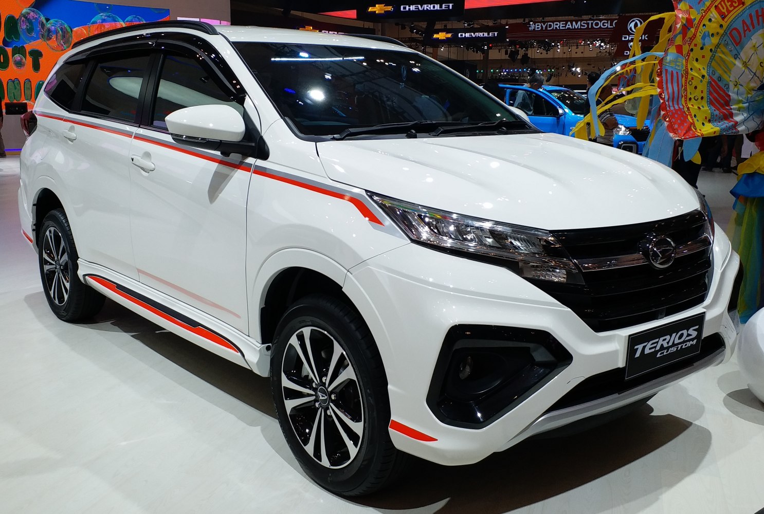 Front side profile of SUV with headlights, grille, sporty trim, and alloy wheels.