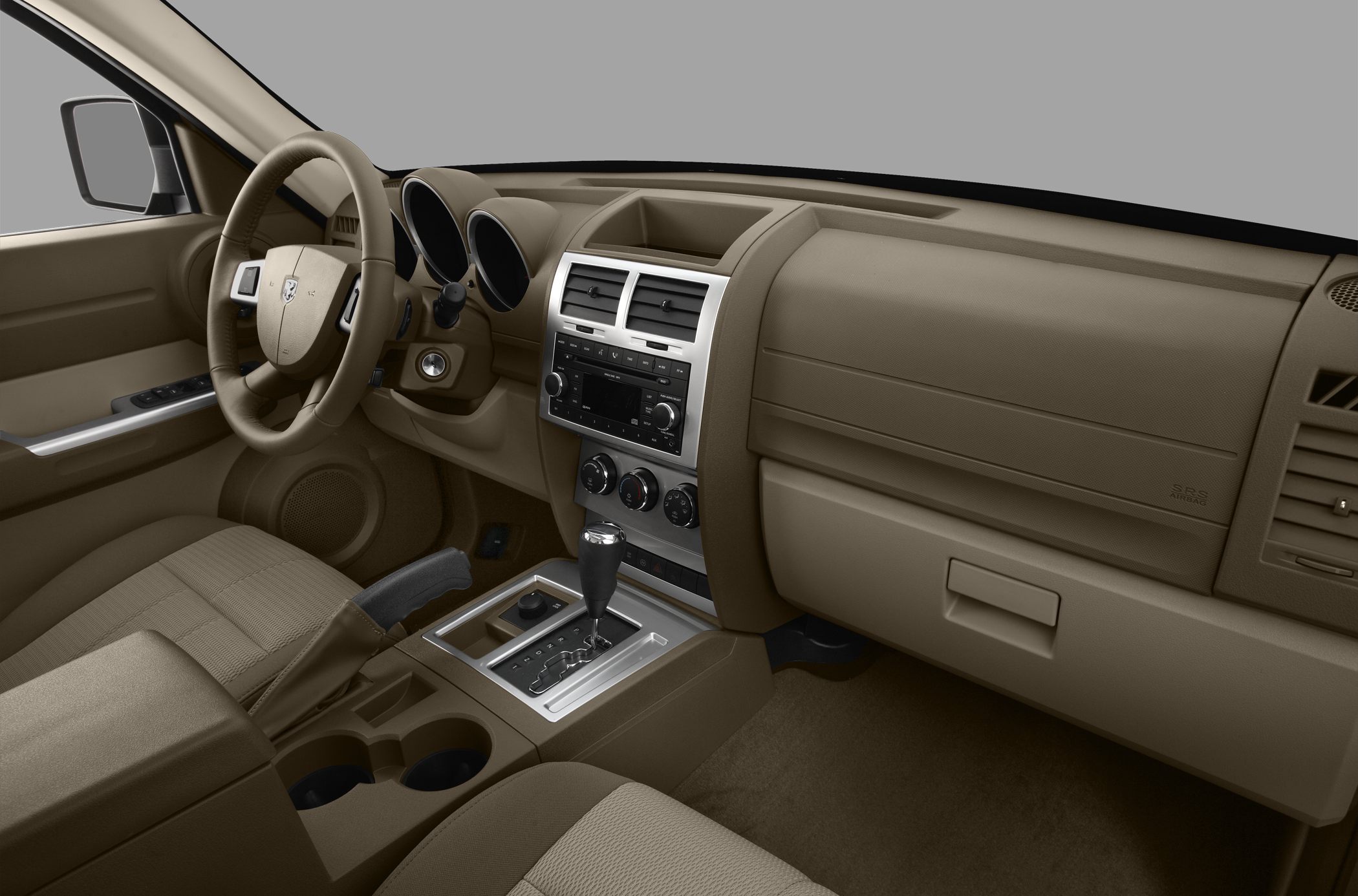 Beige car interior with dashboard, steering wheel, and center console