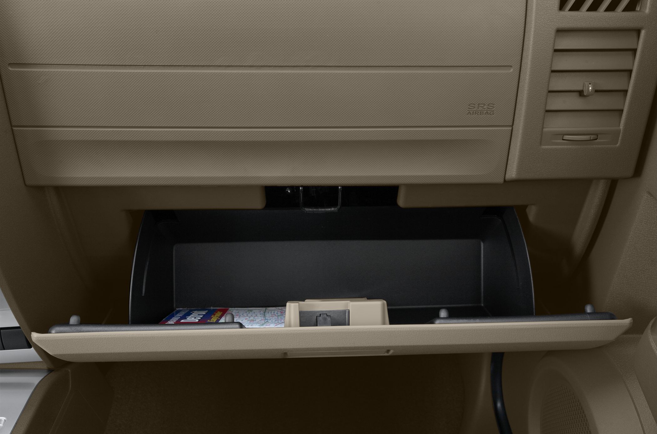 Open glove box with map storage and beige dashboard interior