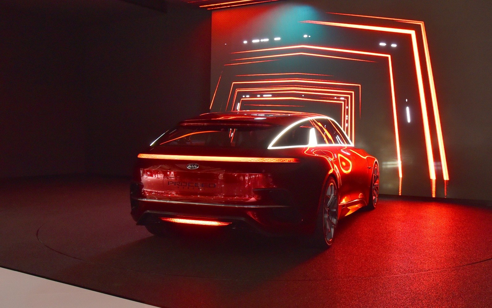 Rear view of a sporty hatchback with continuous LED light bar and futuristic design elements.