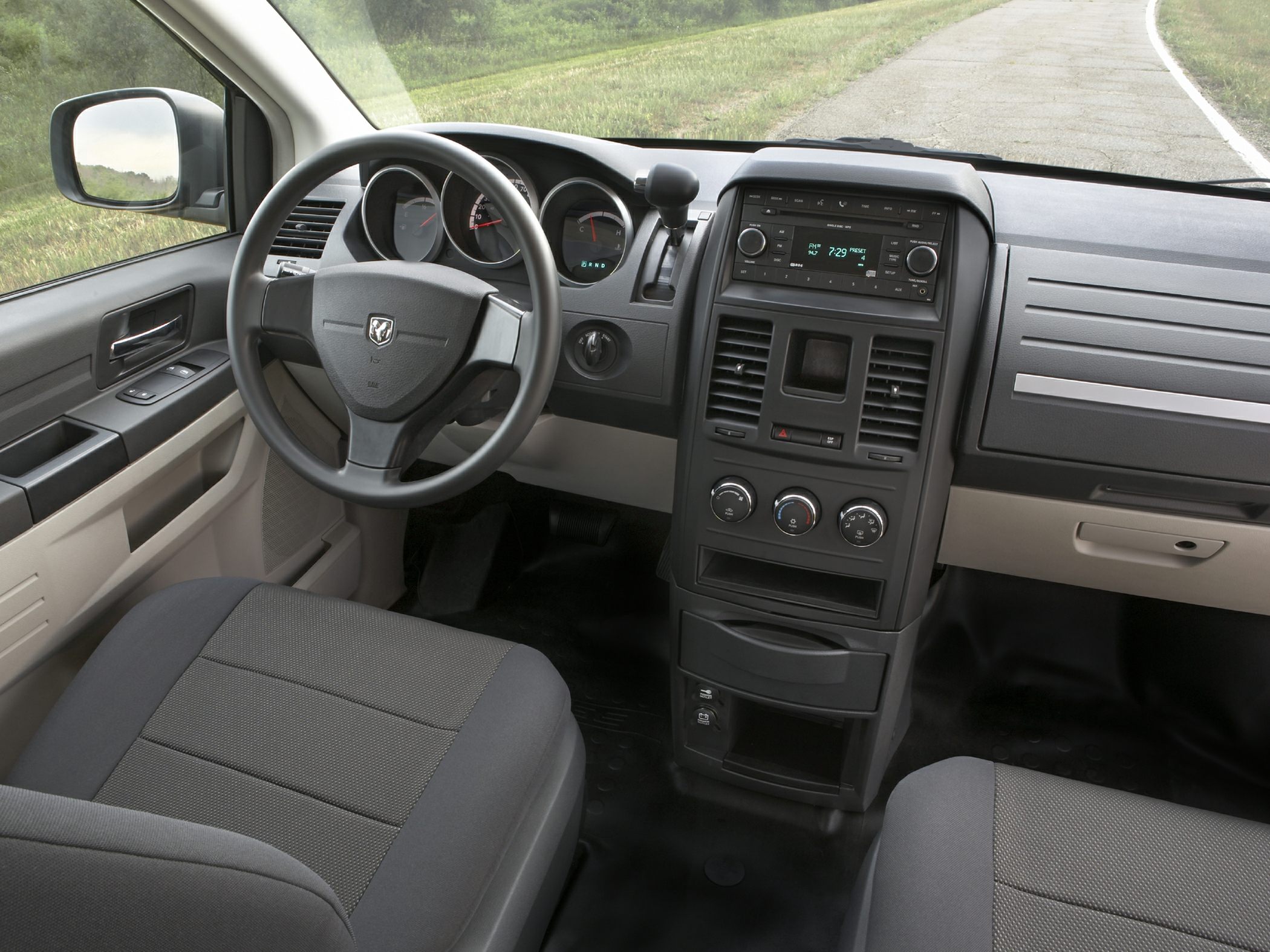 Interior dashboard and steering wheel with central console and control knobs