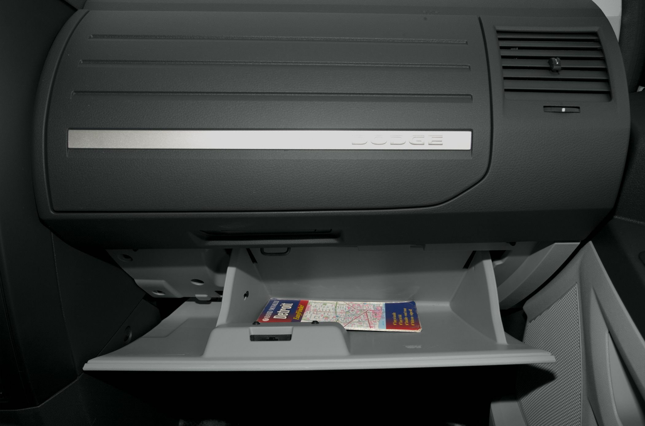Open glove compartment with folded map inside