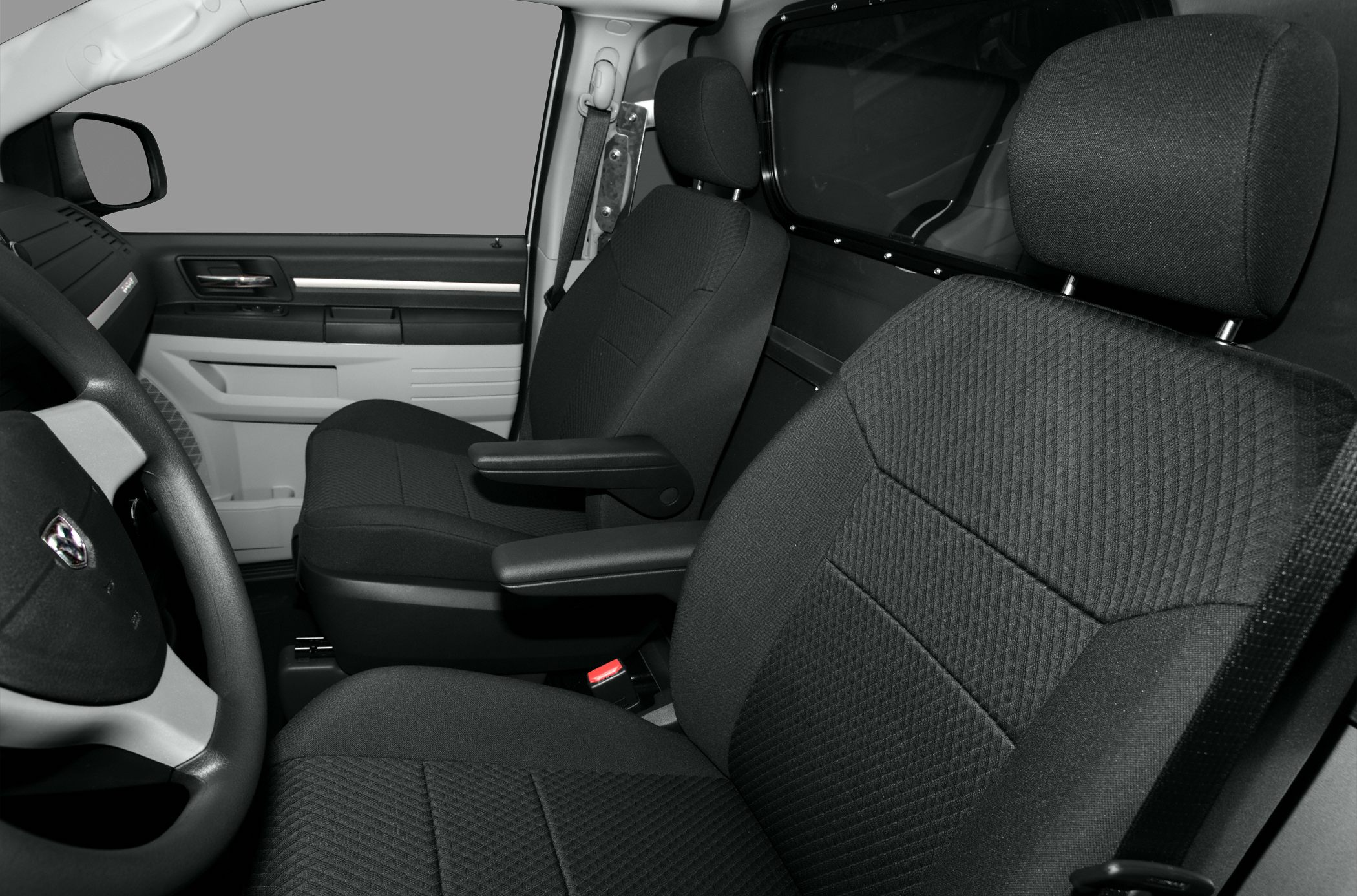 Front interior seats with armrests and fabric upholstery
