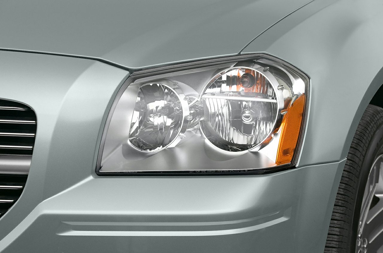 Close-up of front headlight and fender with turn signal reflector