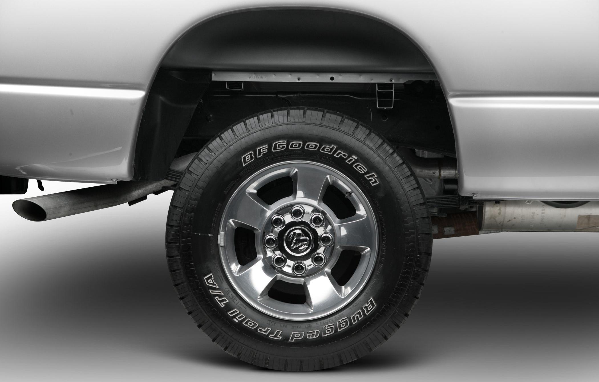 Alloy wheel with branded tire and visible exhaust pipe