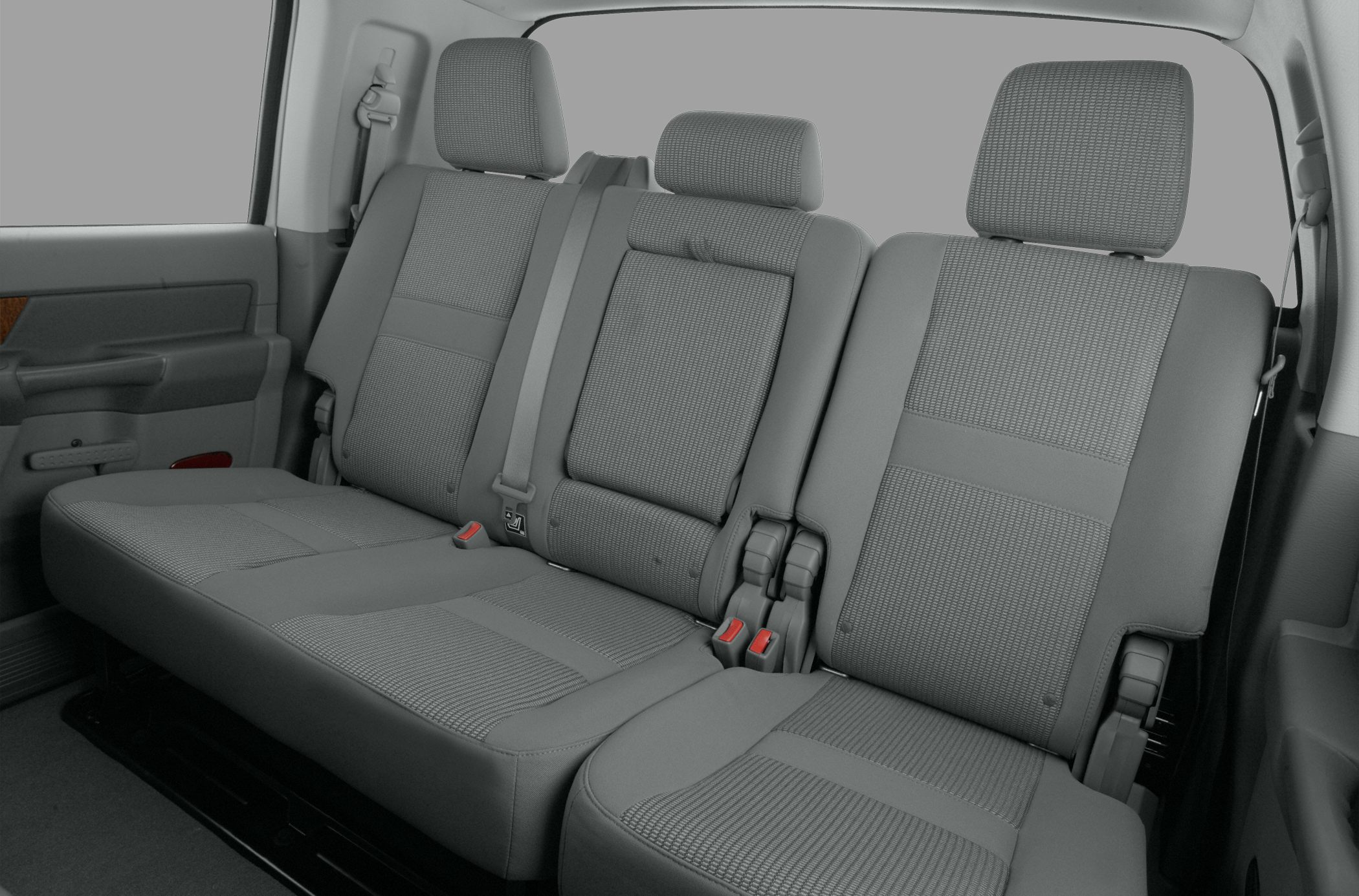Rear seat of truck with fabric upholstery, headrests, and seat belts