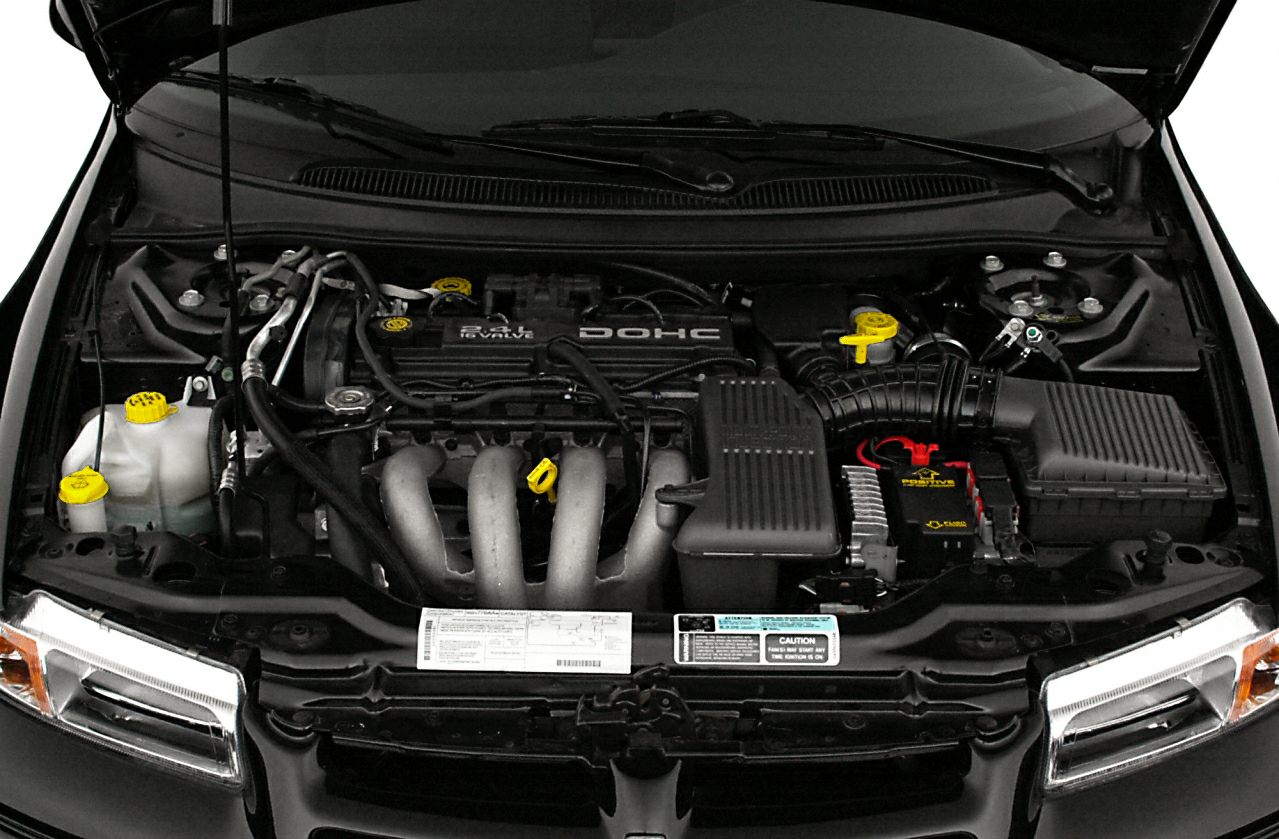 Close-up of a DOHC engine with highlighted yellow fluid caps