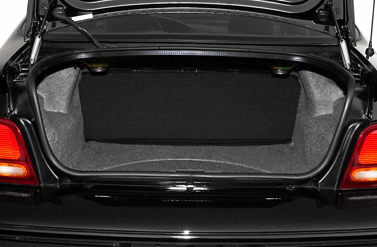 Open trunk interior with spacious, clean cargo area and red taillights.