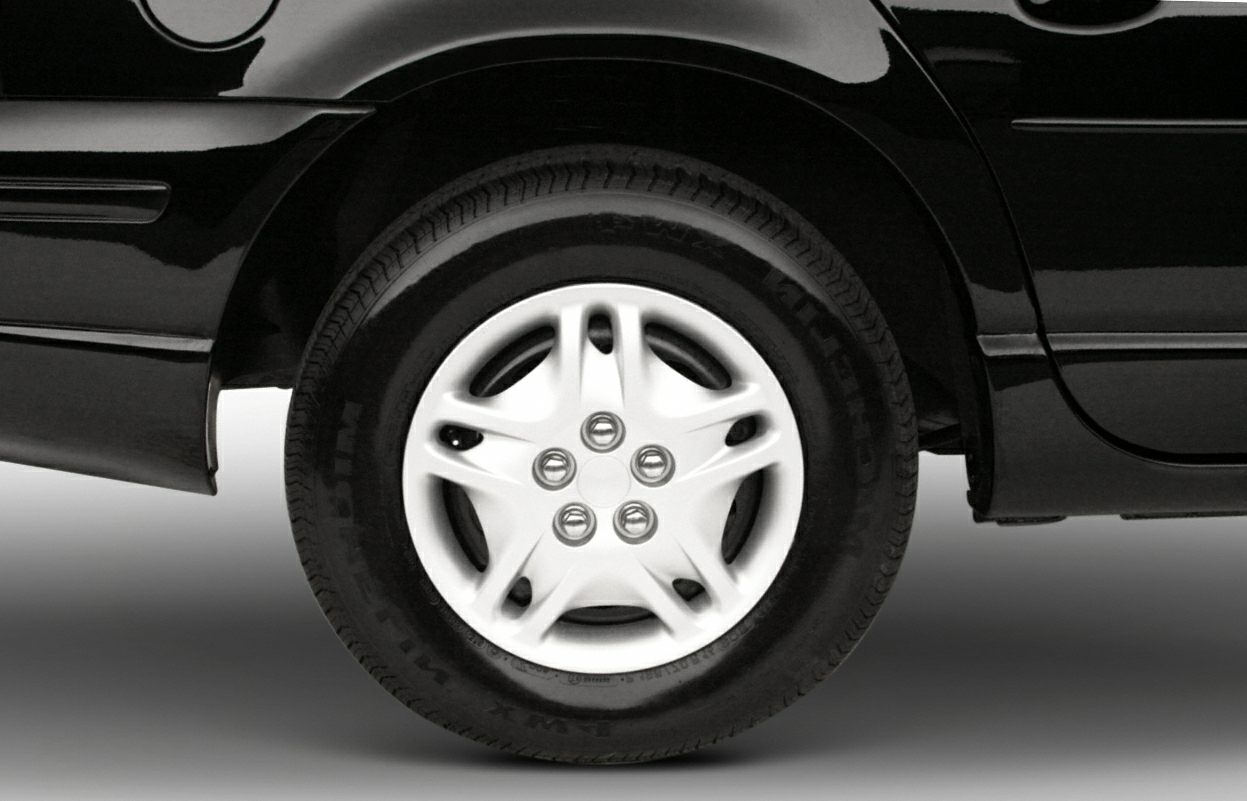 Close-up of alloy wheel and tire on a black car rear section