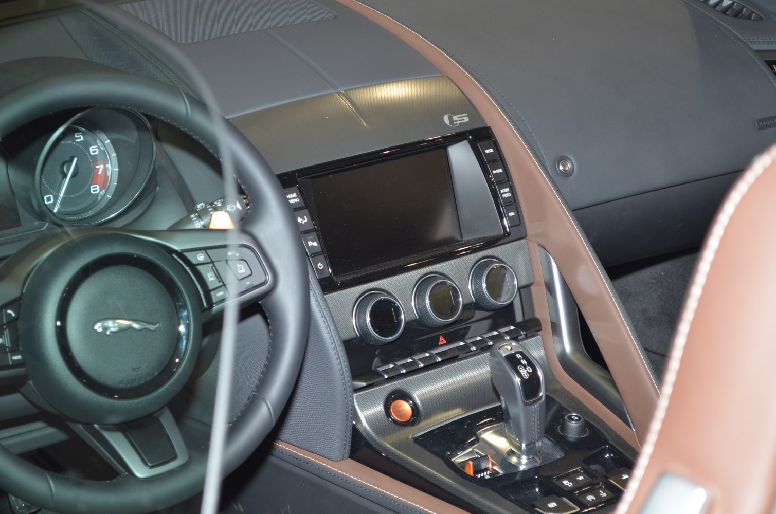 Dashboard with steering wheel, touchscreen display, and gear shifter