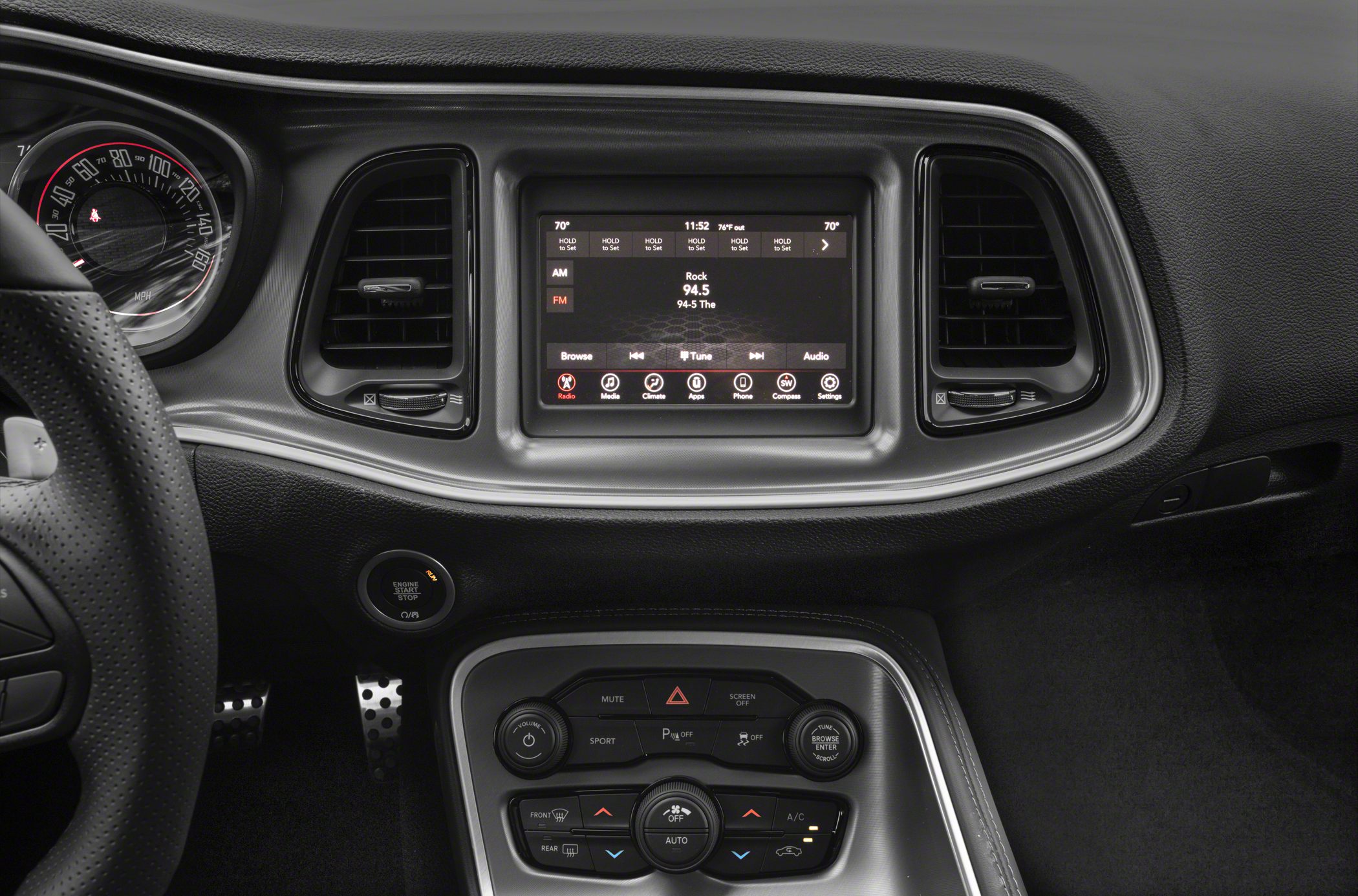 Touchscreen infotainment display and dashboard controls with air vents.