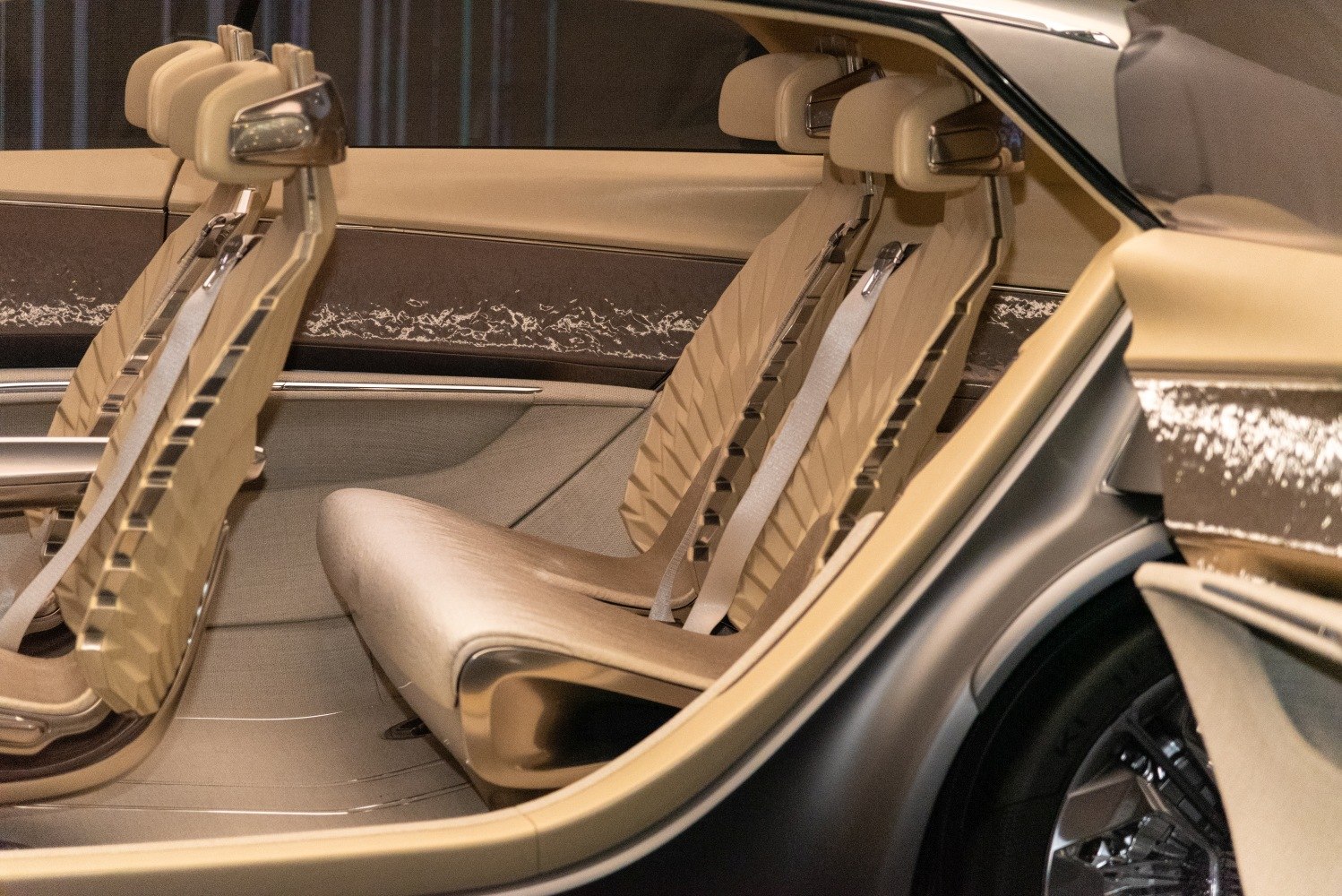 Futuristic sculpted seats with integrated headrests and seat belts