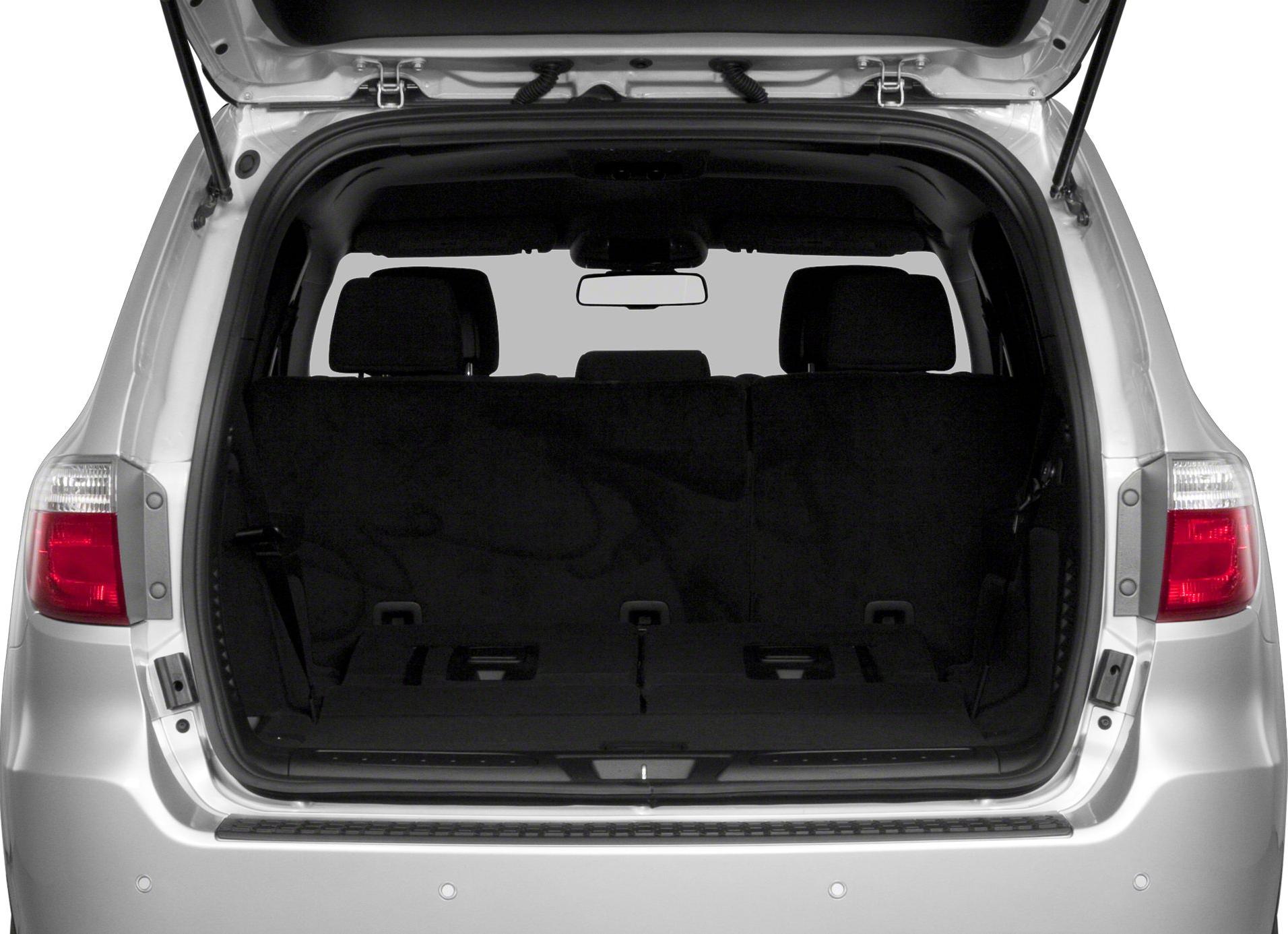 Open rear cargo area with folded third-row seats and visible taillights.