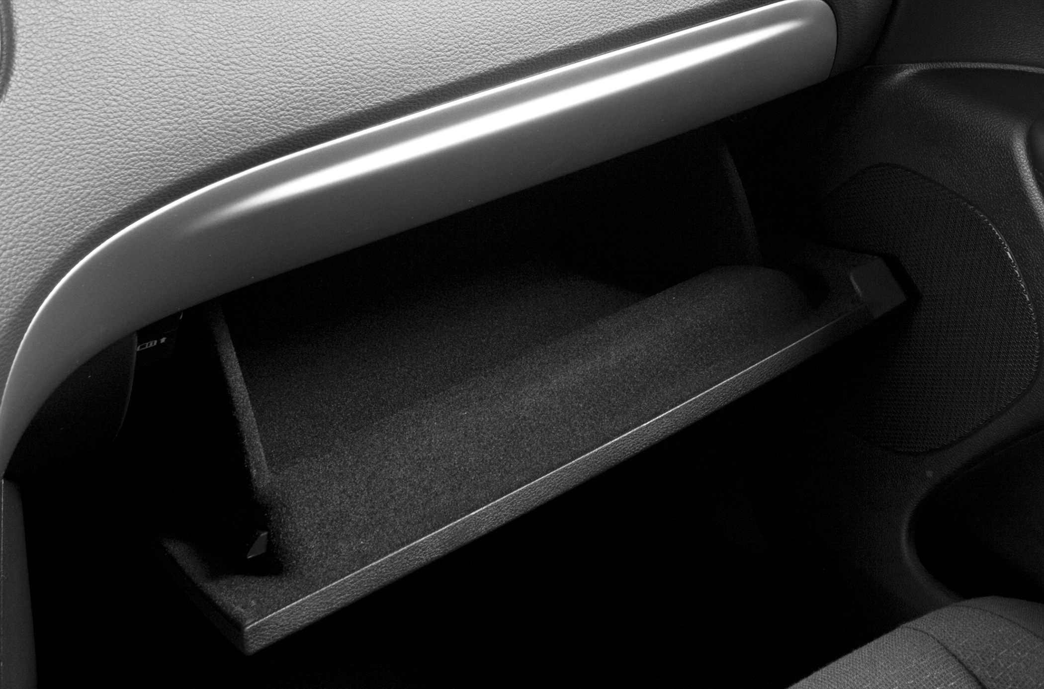 Open glove compartment inside vehicle interior