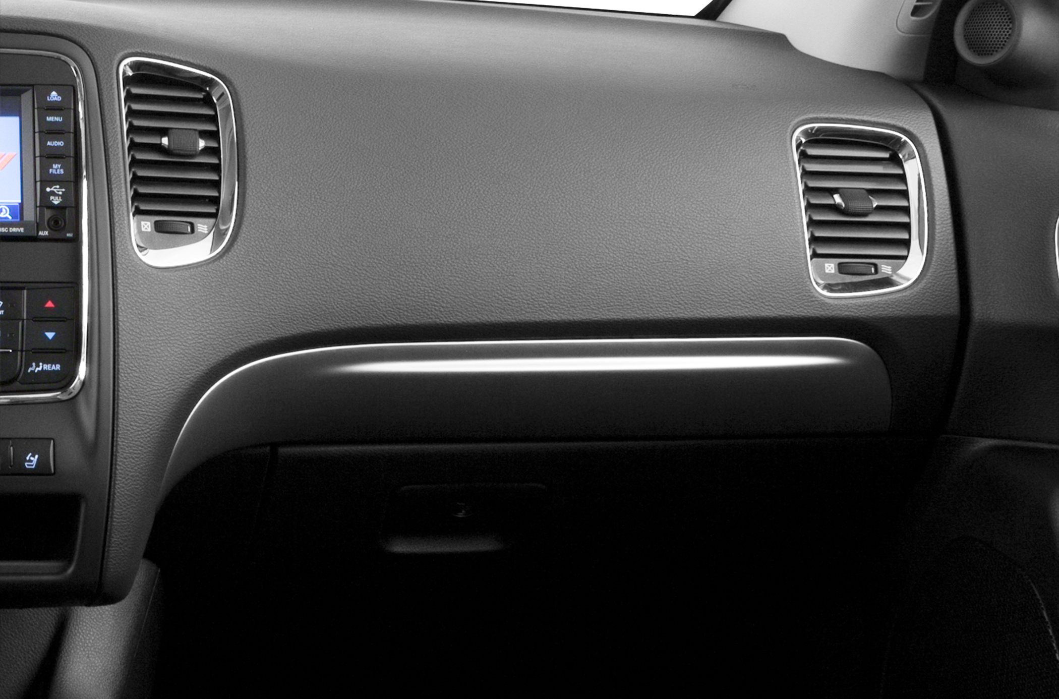 Dashboard and dual chrome-accented air vents on a vehicle interior