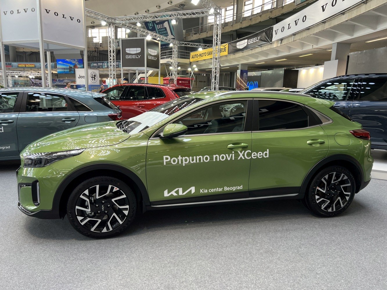 Side profile of a green compact SUV with distinctive alloy wheels