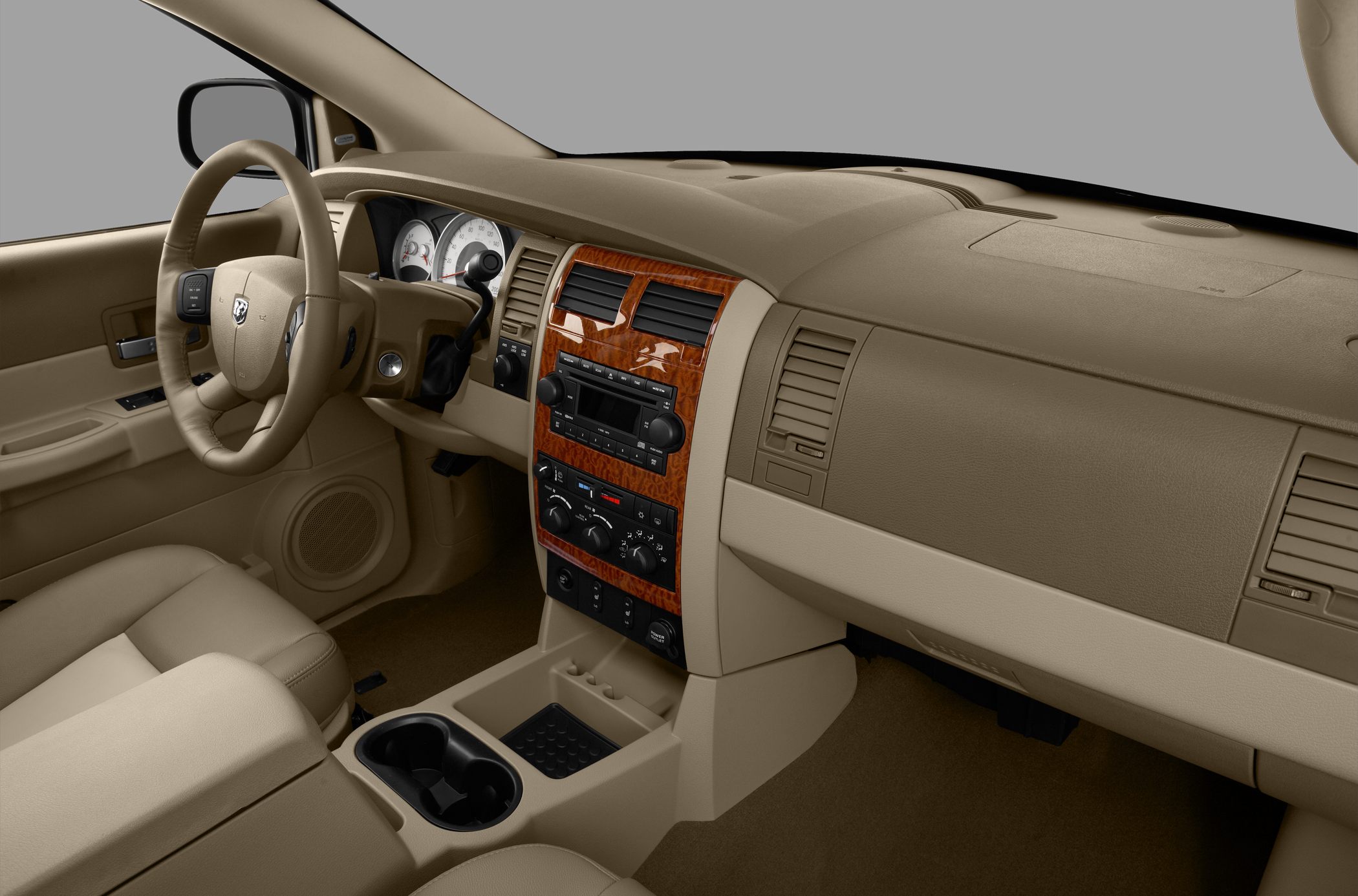 Beige interior with wood trim dashboard and center console with dual cup holders