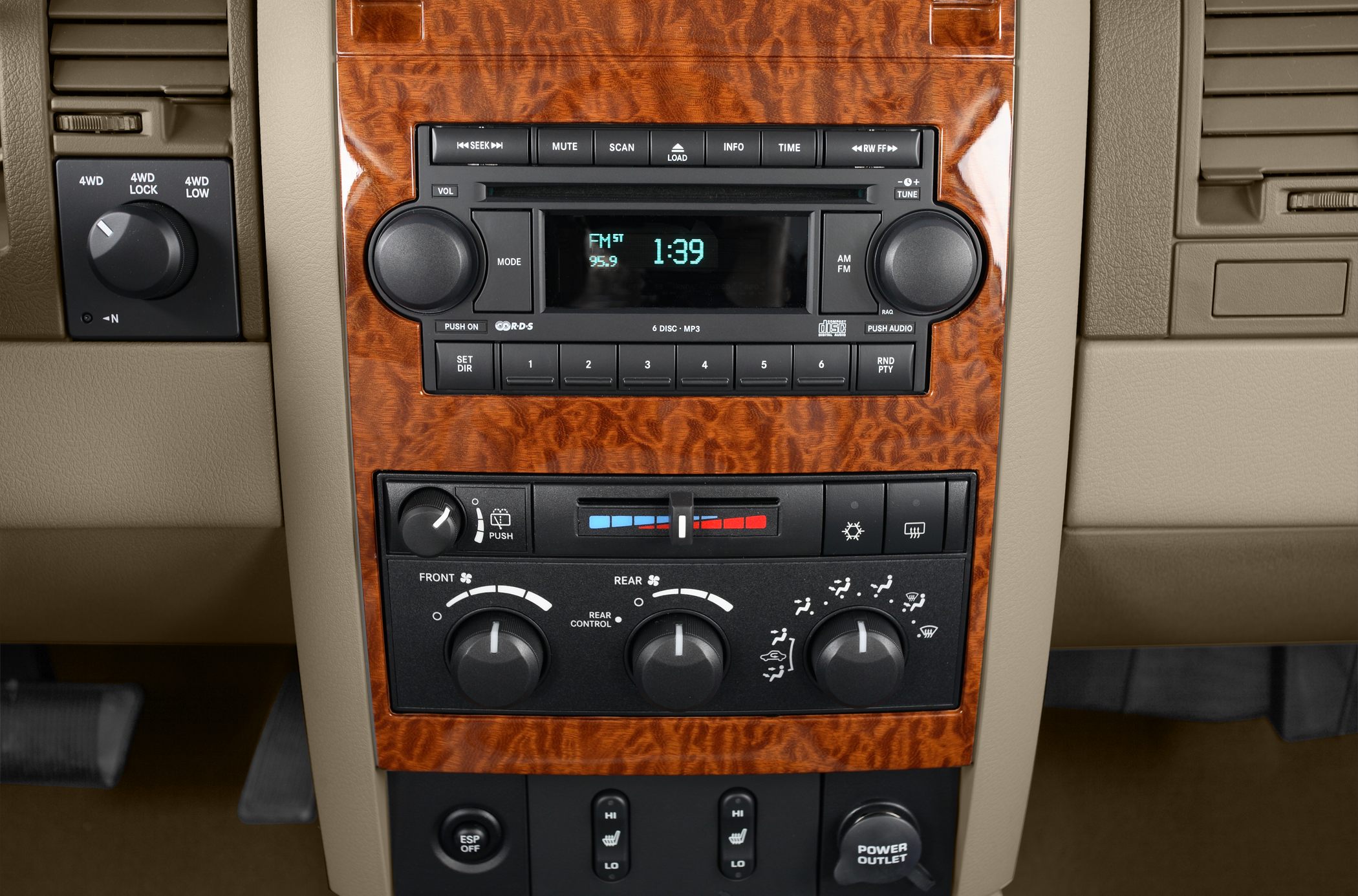 Wood grain interior panel with audio system and climate controls.