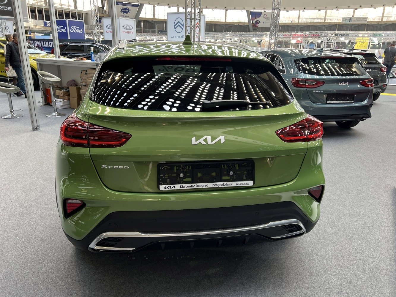 Rear view with updated tail lights and bumper of a green compact SUV