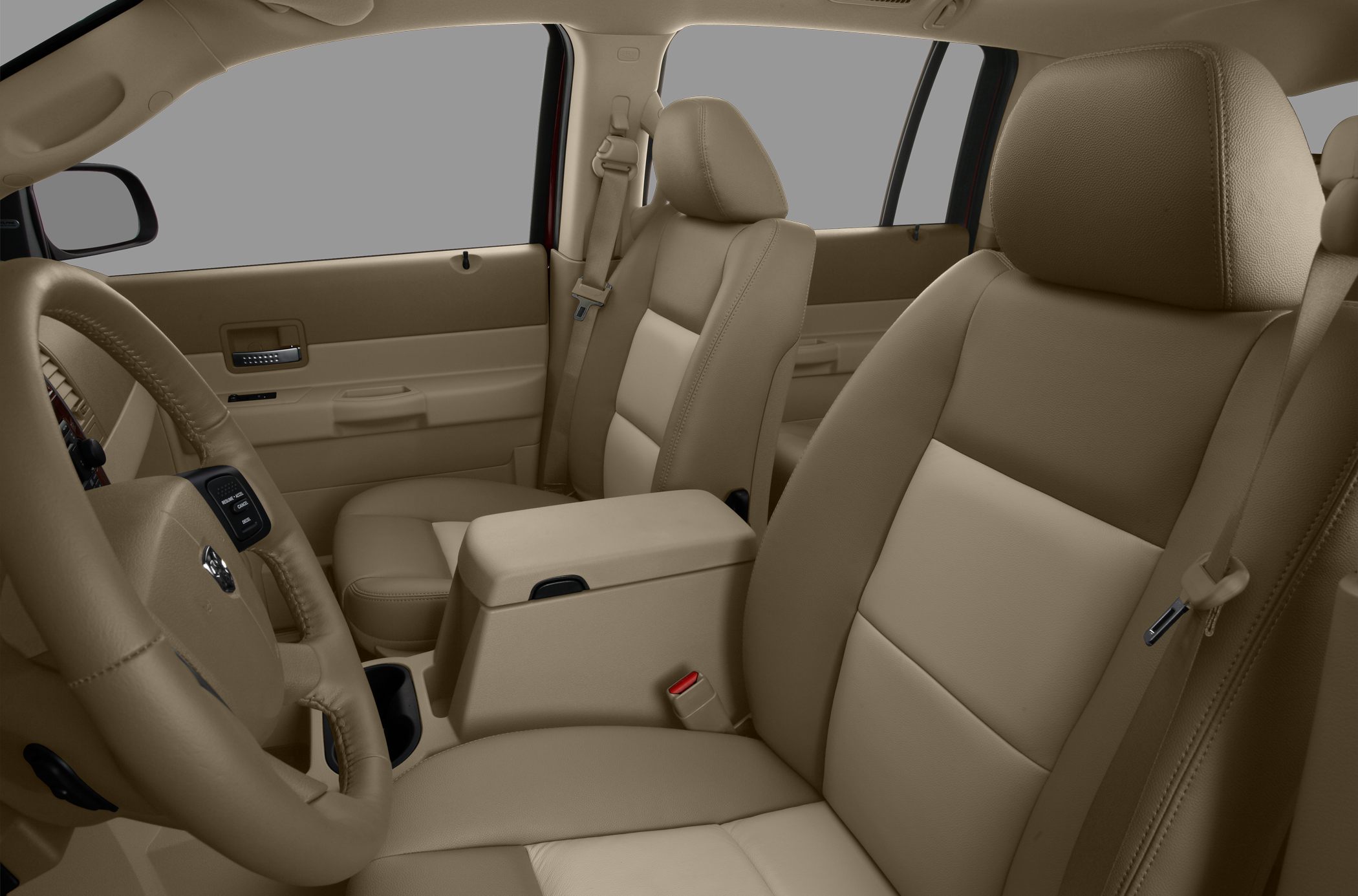 Tan leather front seats and armrest with seatbelt and steering wheel