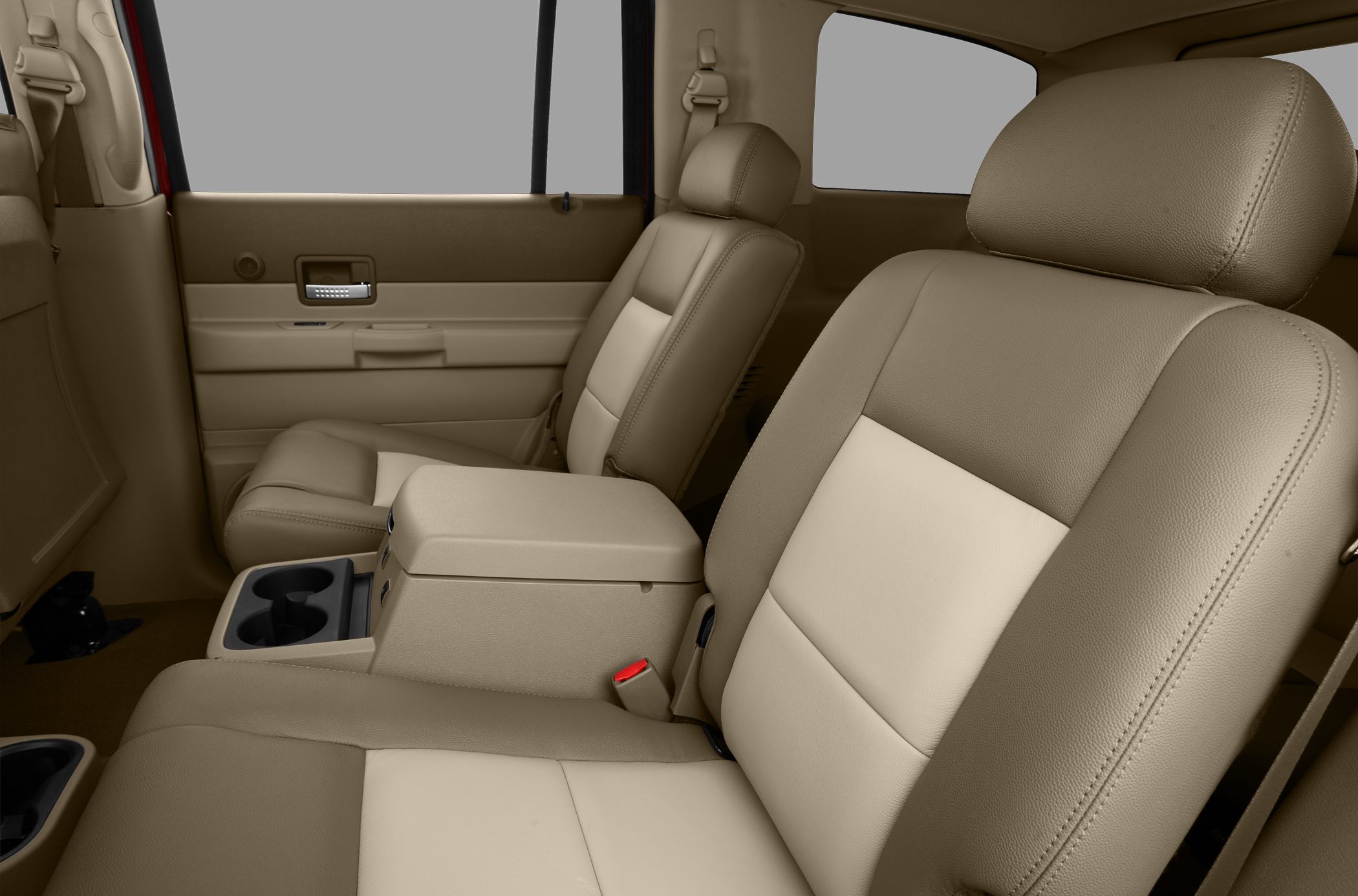Beige leather seats with center armrest and cup holder.
