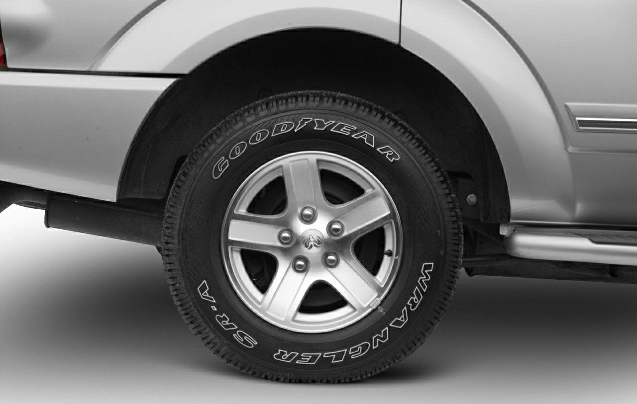 Goodyear Wrangler SRA tire on 5-spoke alloy wheel at rear wheel arch