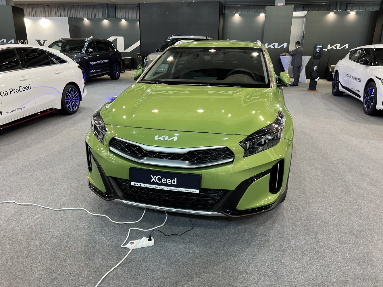 Green car front with modern grille and LED headlights