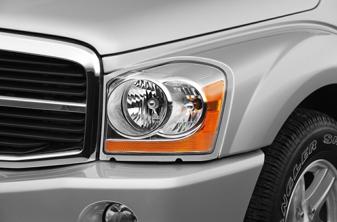Close-up of headlight with integrated amber turn signal and front grille.