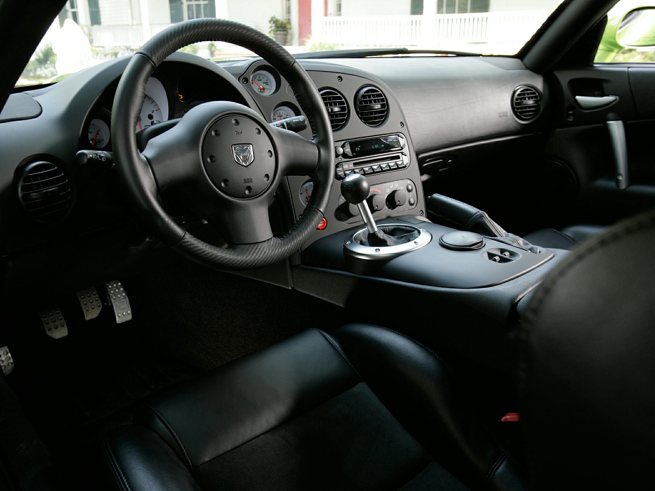 Black leather interior with manual gear shift and round air vents