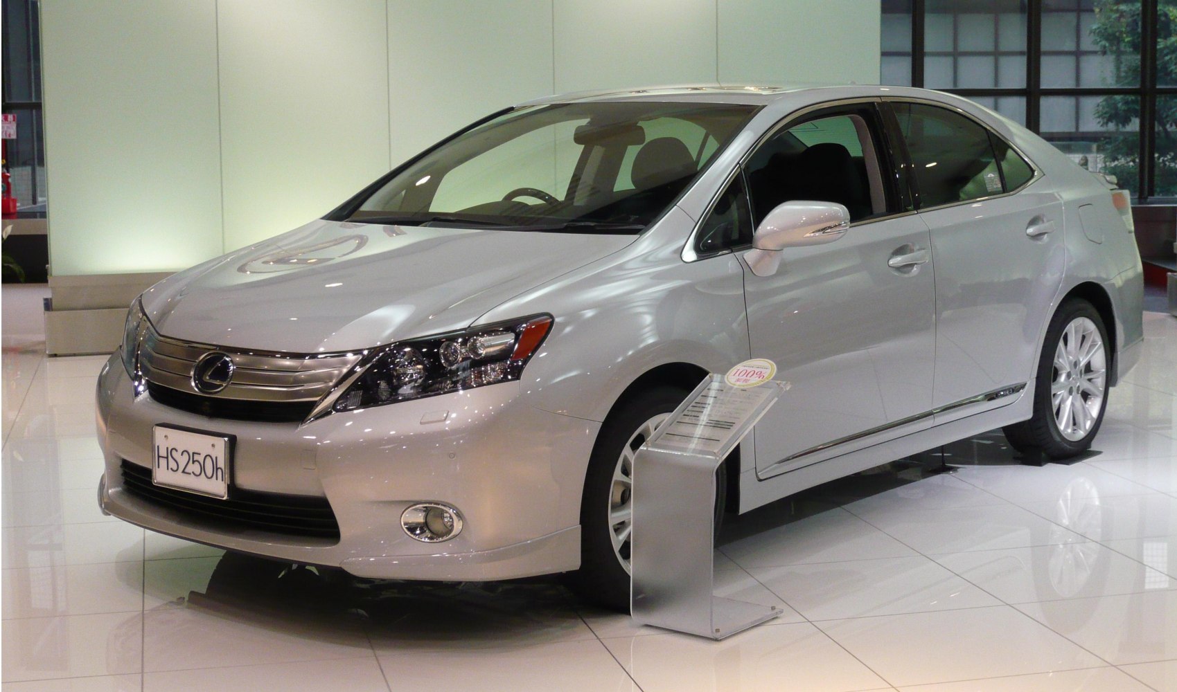 Front and side view of a hybrid sedan with chrome grille.