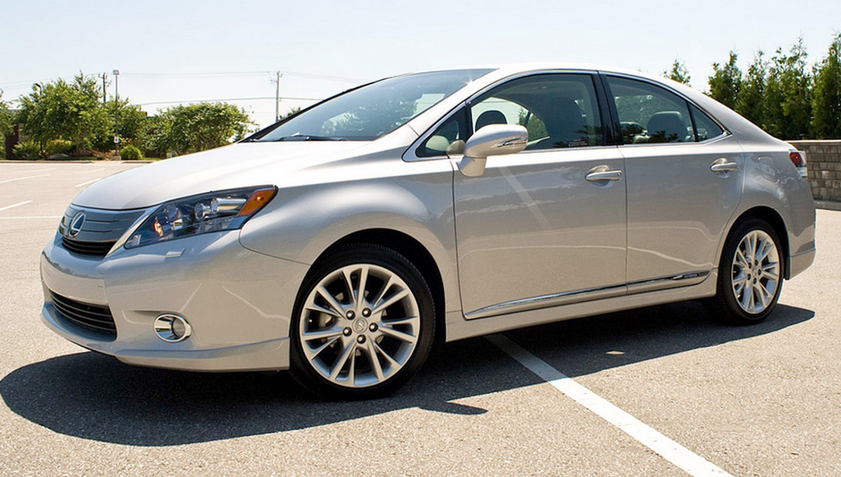 Silver mid-size hybrid sedan with alloy wheels and modern headlights