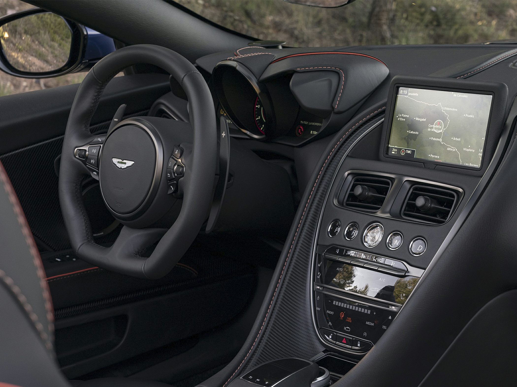 Luxury car interior with dashboard, steering wheel, and infotainment screen
