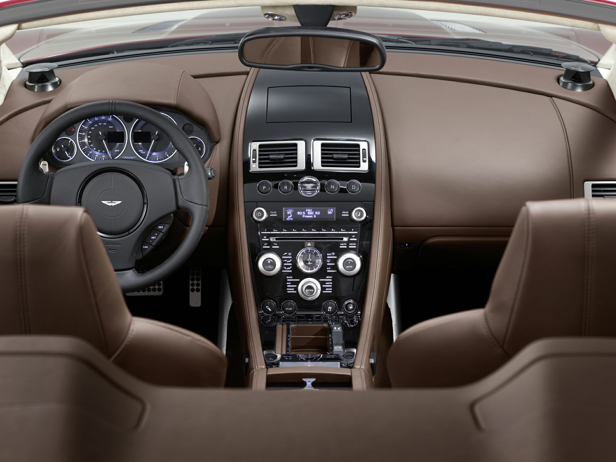 Luxury convertible dashboard and steering wheel in brown leather interior