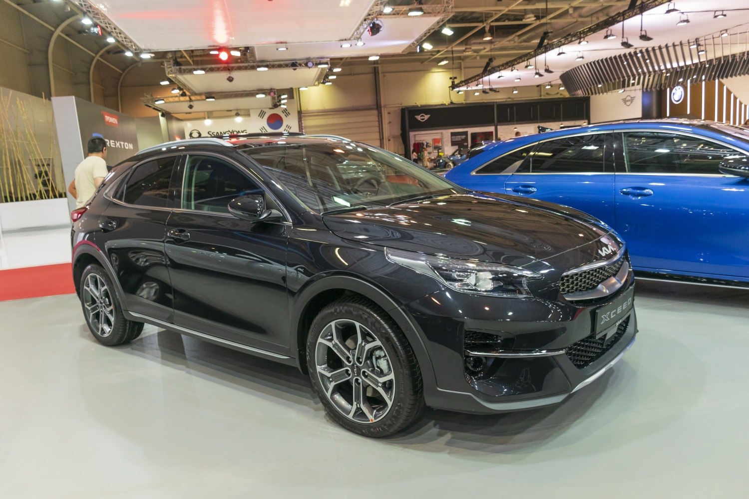 Front-side view of sleek black vehicle with alloy wheels and sharp headlights