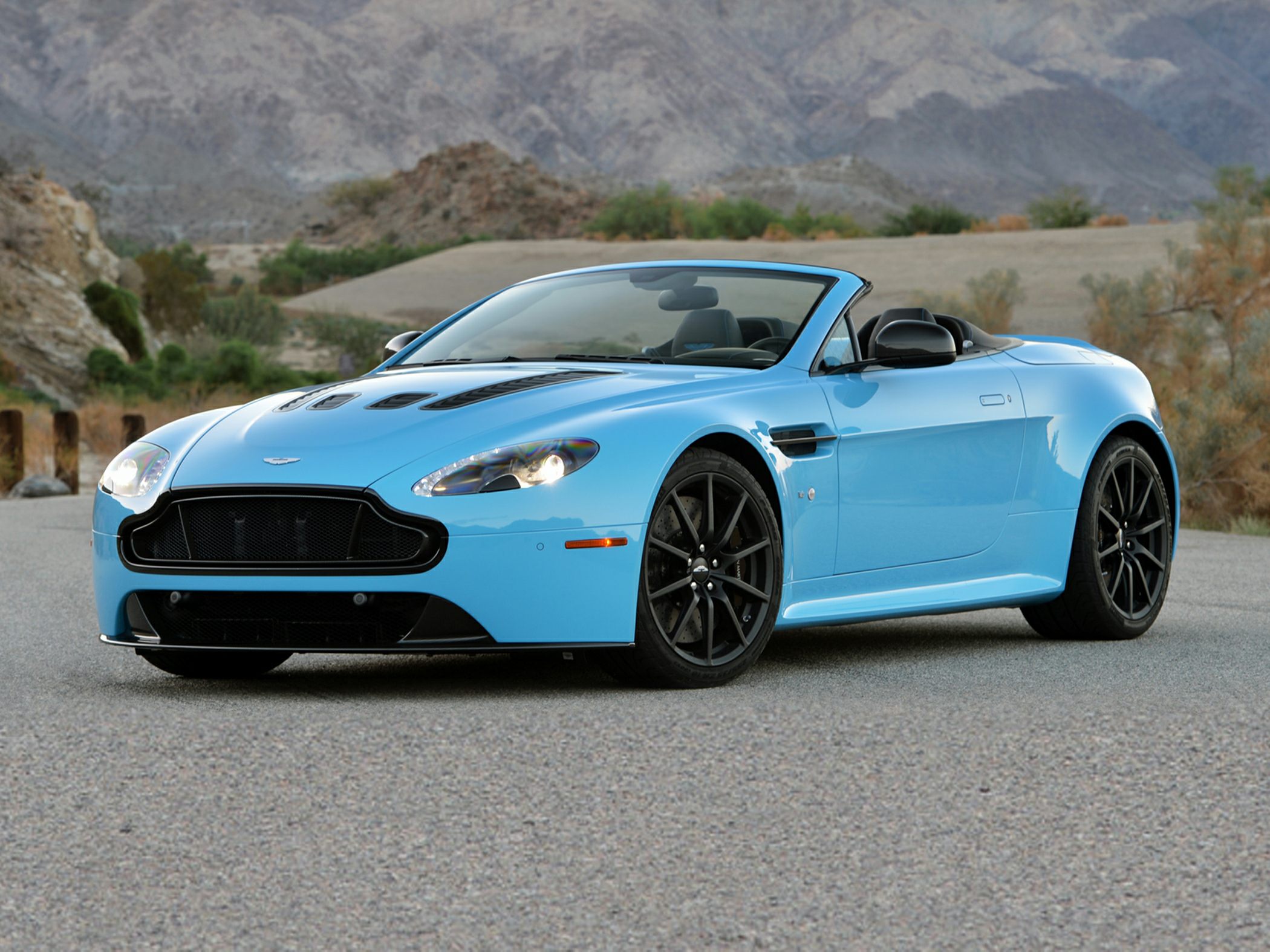 Convertible sports car with hood vents and black alloy wheels