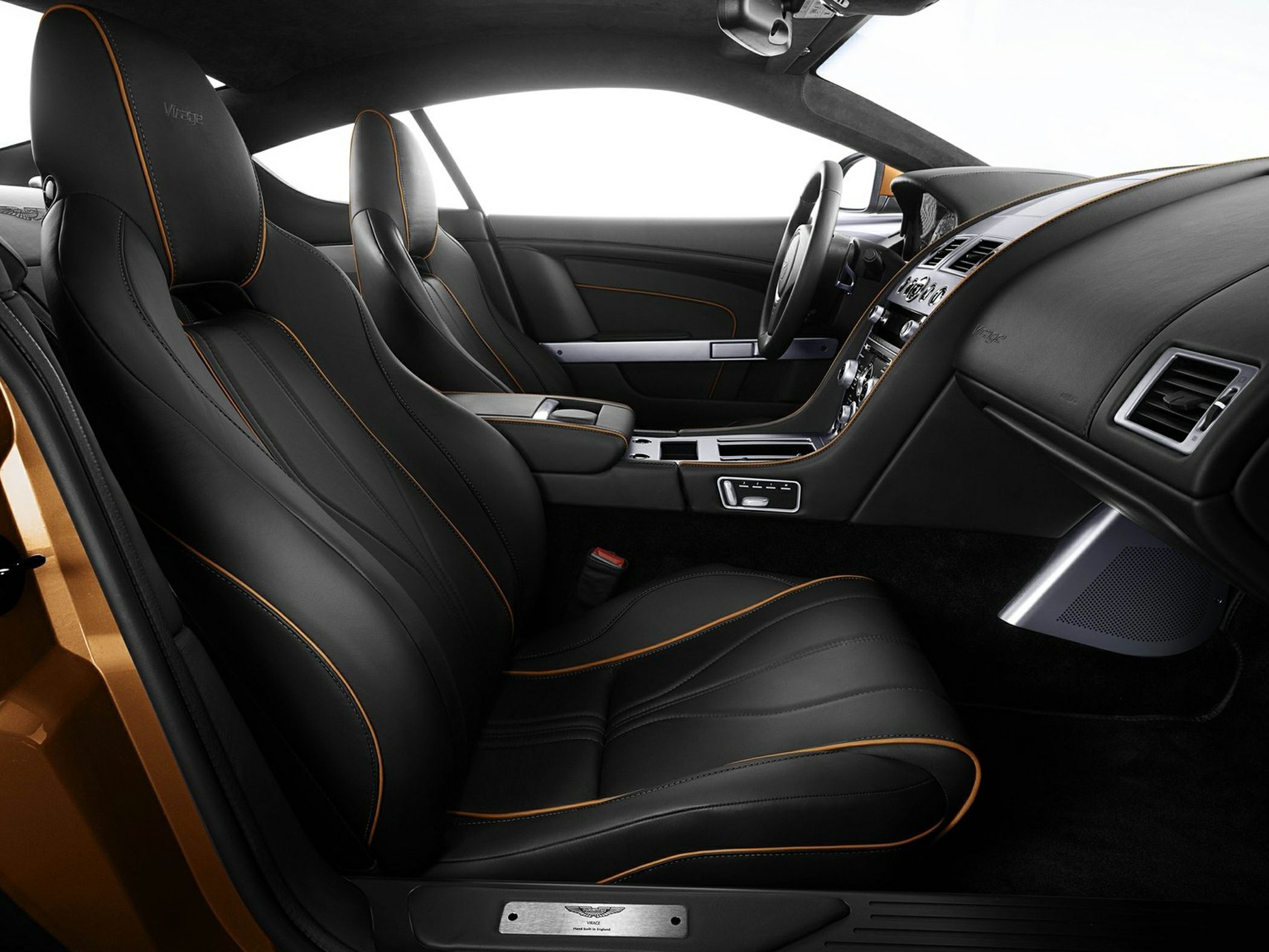 Black leather seats with orange stitching and luxury ergonomic interior.