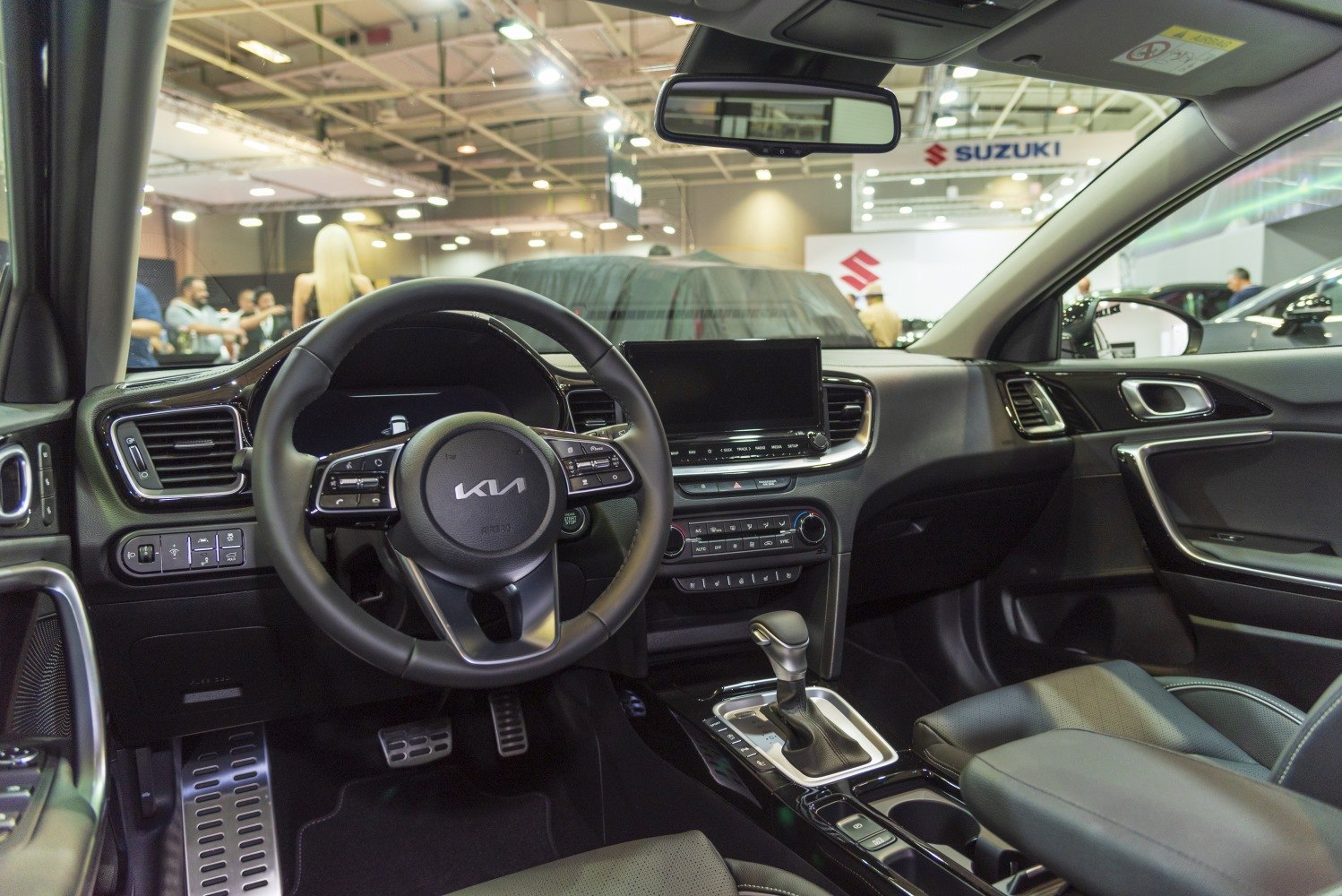 Modern car interior with dashboard, touchscreen, and multifunction steering wheel