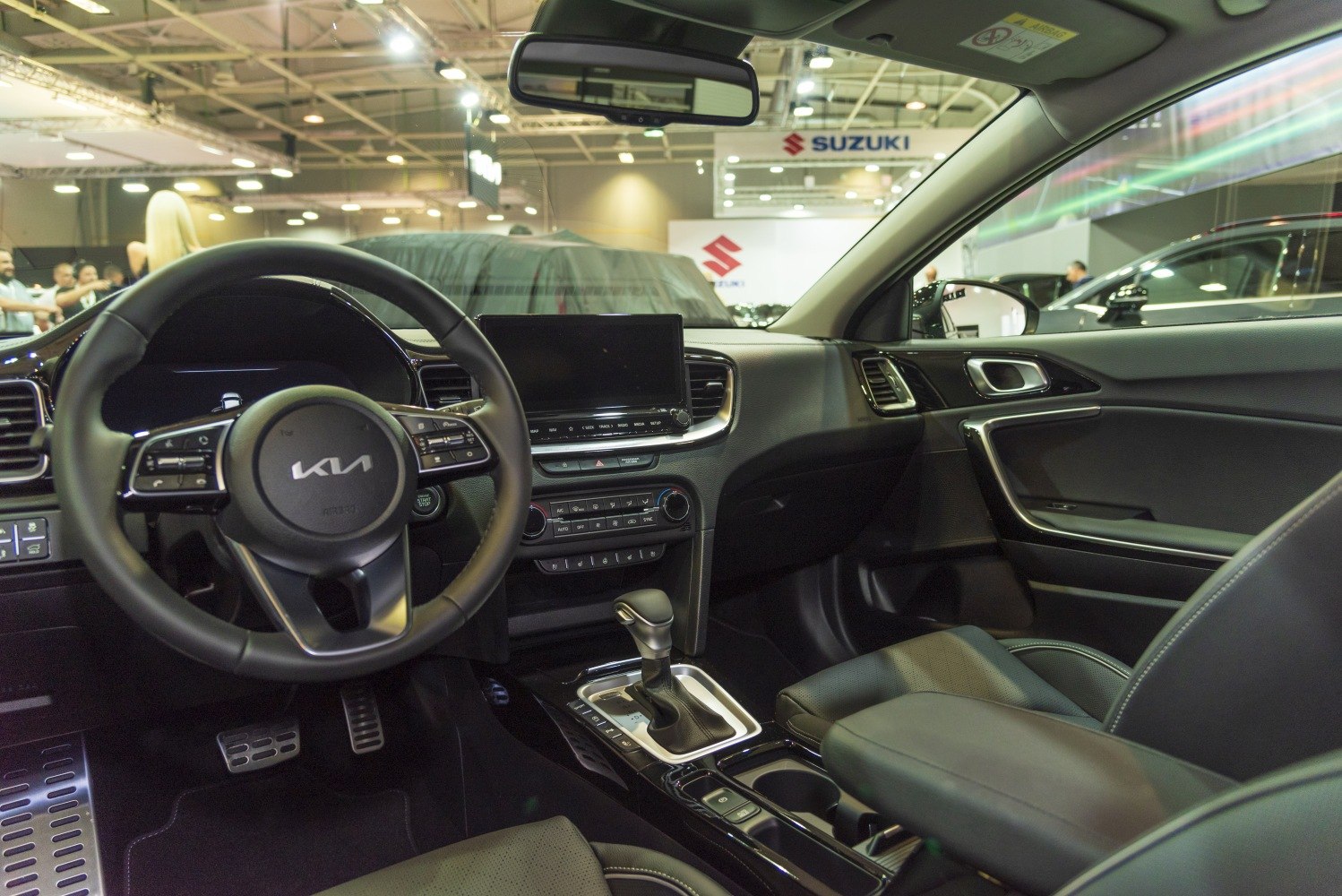Modern steering wheel, touchscreen, gear shifter, and dashboard layout
