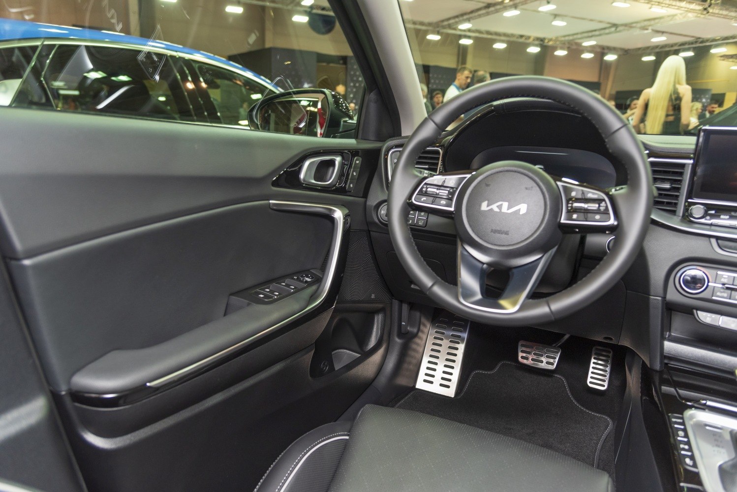Steering wheel with controls and door panel with window buttons.