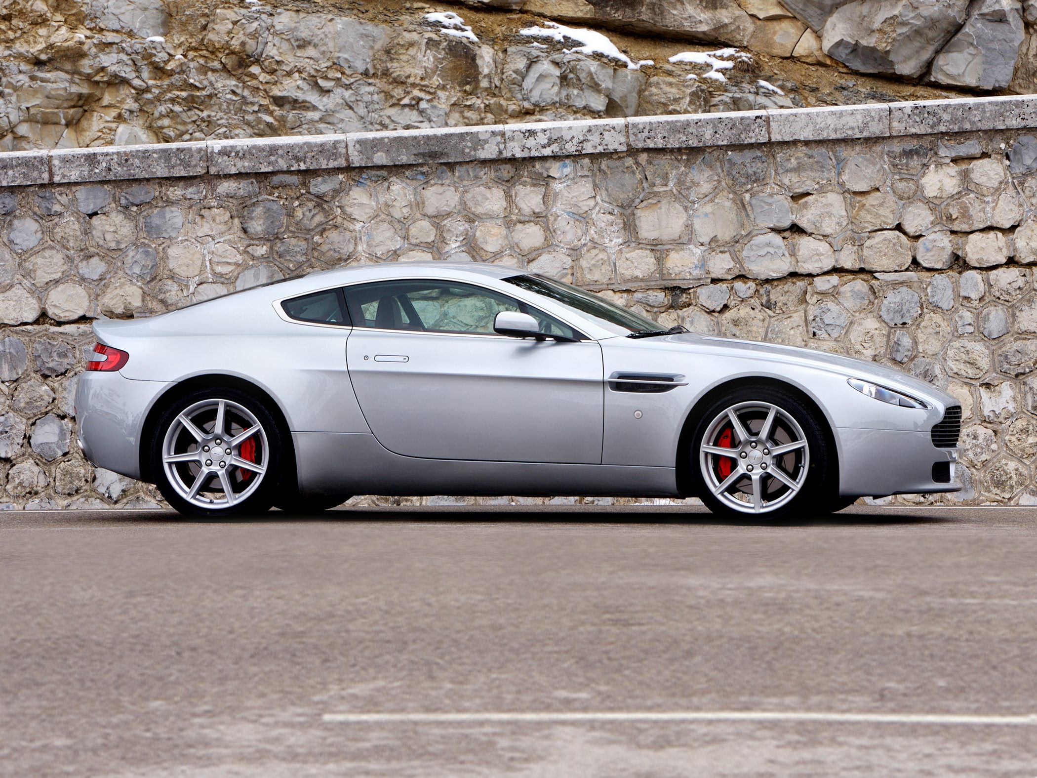 Silver luxury coupe side view with alloy wheels and red brake calipers