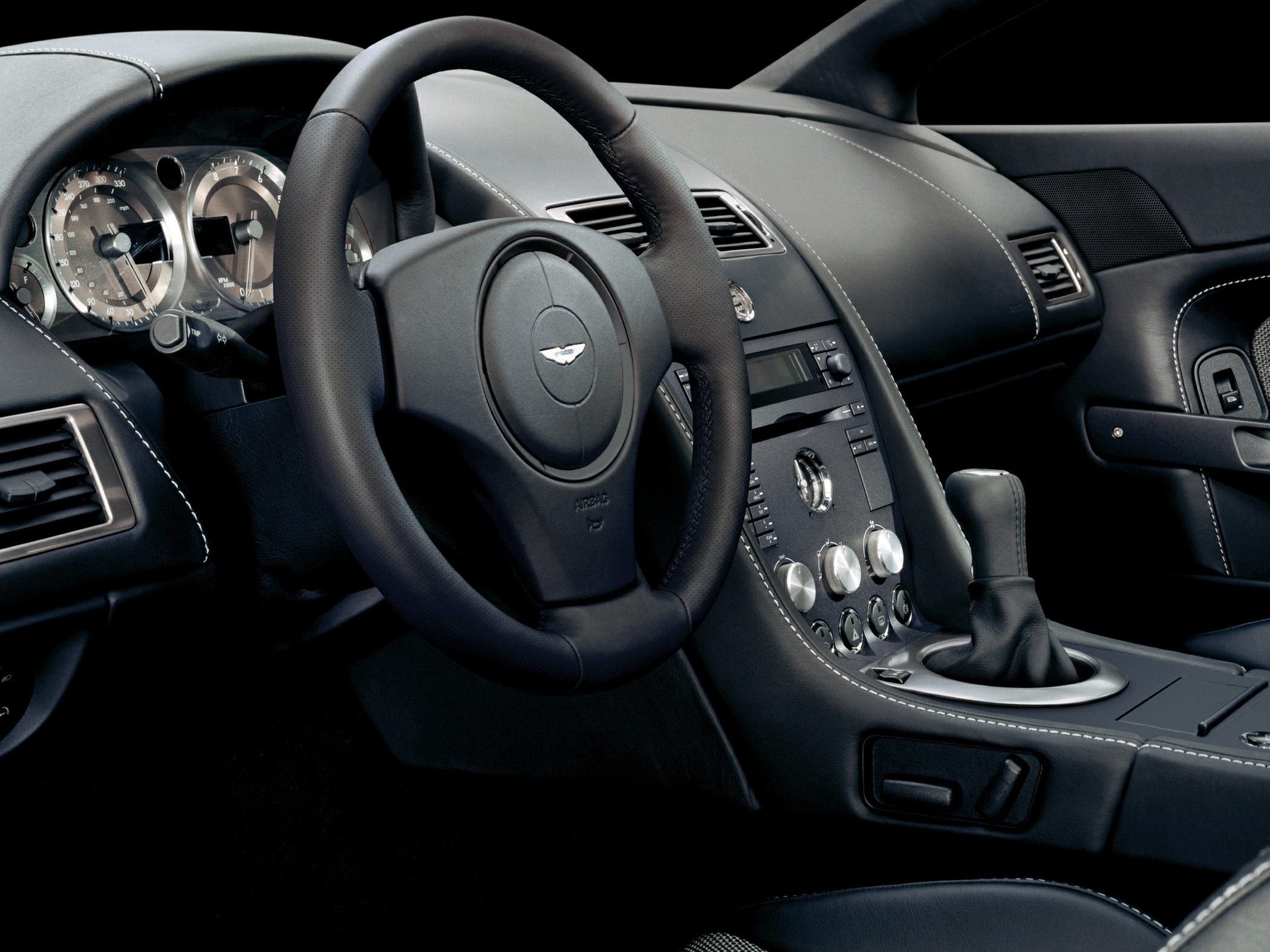 Luxury sports car interior with dashboard and steering wheel