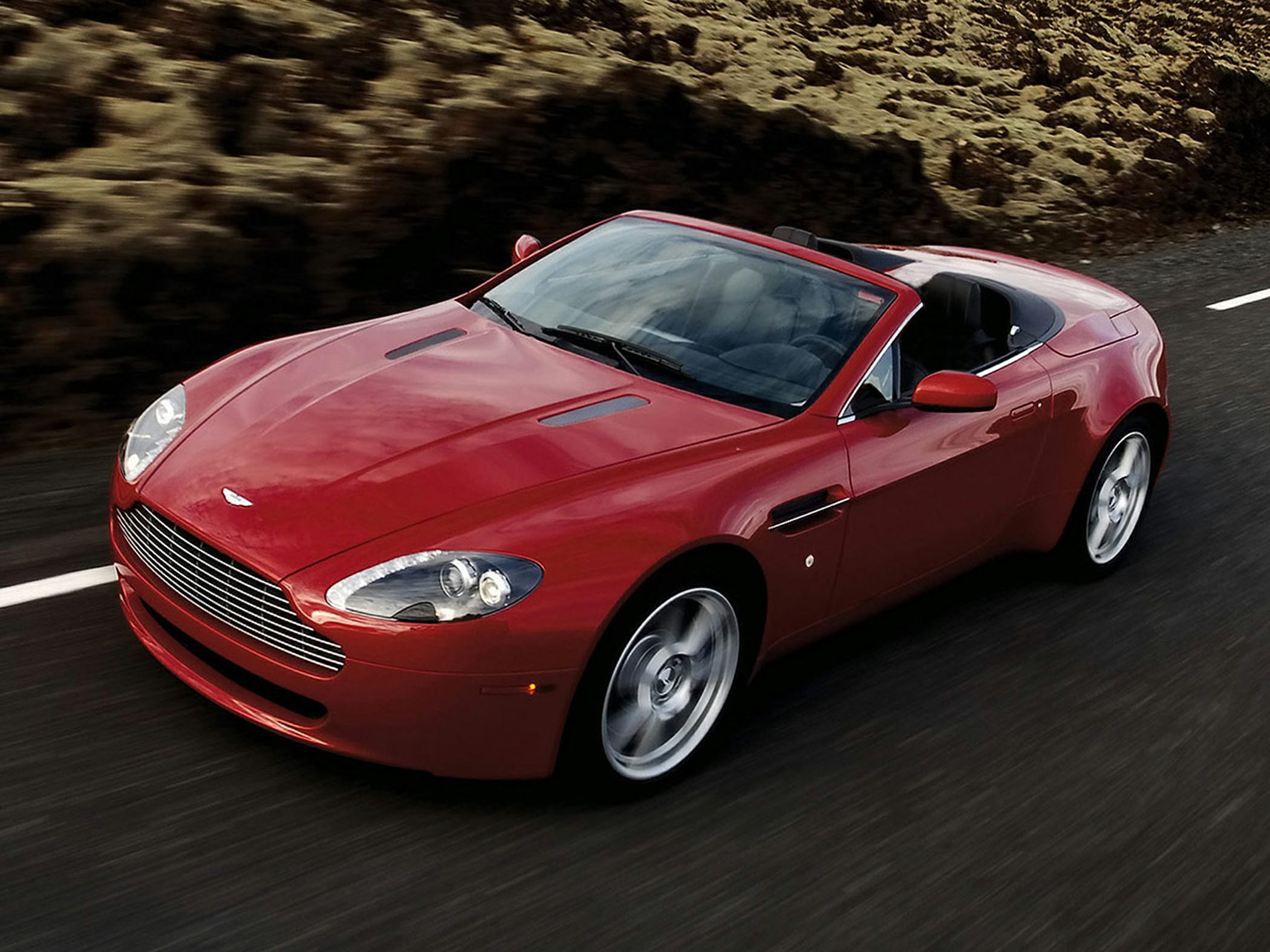 Red convertible sports car with sleek aerodynamic design and alloy wheels