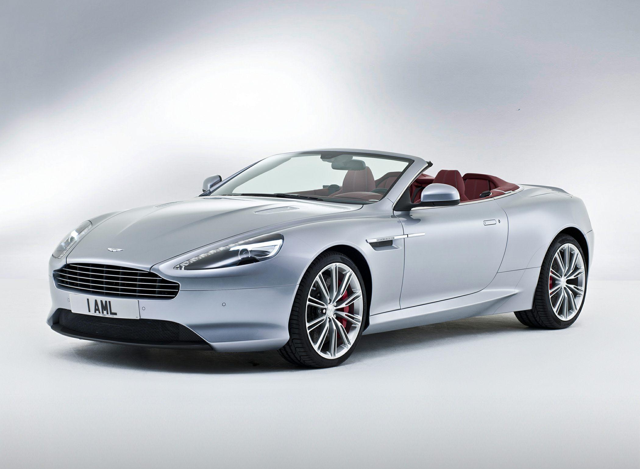 Convertible with silver exterior and red leather seats, featuring sporty alloy wheels.