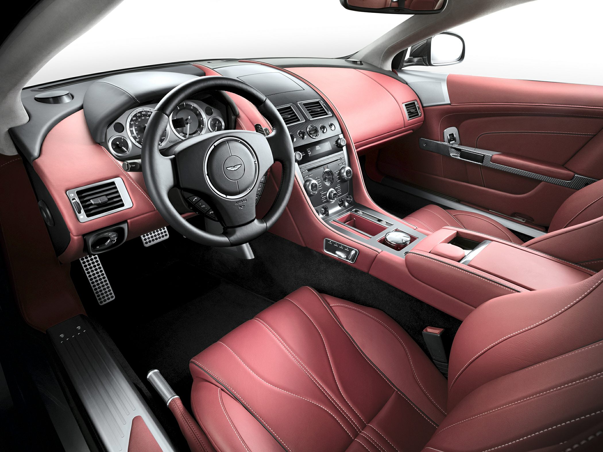 Red leather interior with detailed dashboard and steering wheel